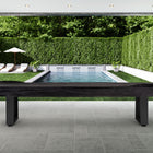 American Heritage Lanai 9' Outdoor Shuffleboard Table in Obsidian Black on a poolside patio.