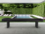 American Heritage Lanai 9' Outdoor Shuffleboard Table in Obsidian Black on a poolside patio.