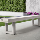 American Heritage Lanai 9' Outdoor Shuffleboard Table in Pearl White on patio with flowers and hedge.