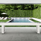 American Heritage Lanai 9' Outdoor Shuffleboard Table in Pearl White on a patio by a pool.