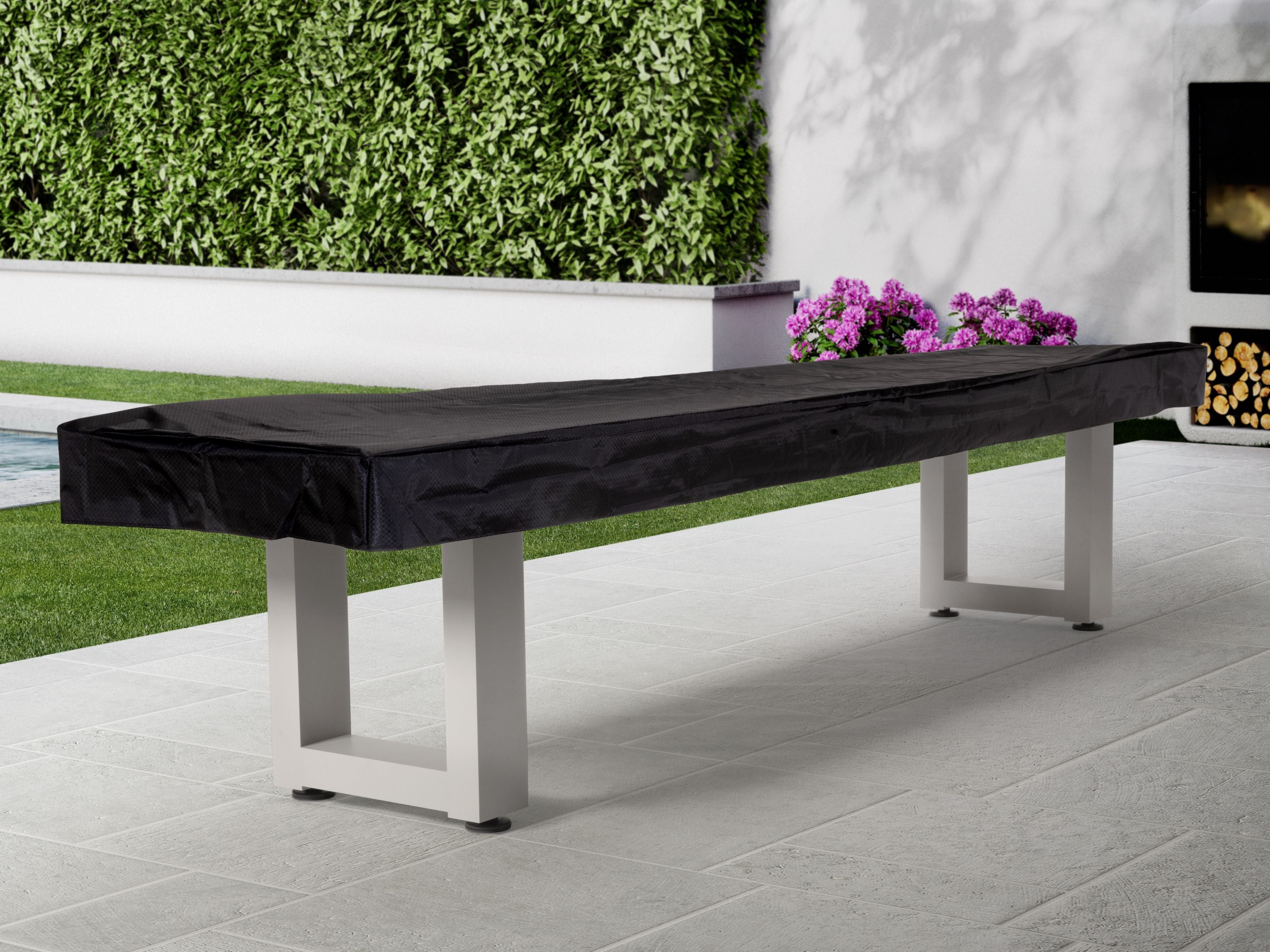 American Heritage Lanai 9' Pearl White Outdoor Shuffleboard Table on patio by the garden.