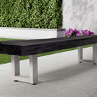 American Heritage Lanai 9' Pearl White Outdoor Shuffleboard Table on patio by the garden.
